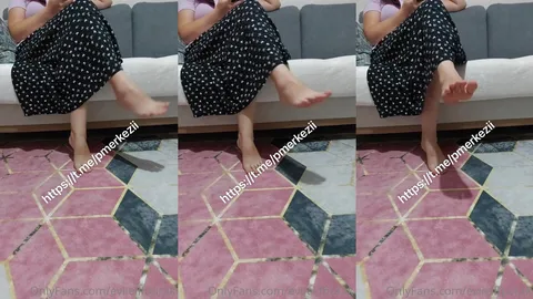 Salonda oturan karısının çıplak ayaklarını çekiyor